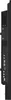 Side view of a black electronic device, likely a monitor or display, showing ports and vents. Voir les images du produit