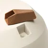 A close-up view of a brown plastic insert being placed into a beige planter. Produktbild-Vorschau