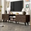A modern dark wood TV stand with a television and various decorative items in a living room setting. Produktbild-Vorschau