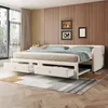 A white sofa bed with blue bedding is shown in a room with wood-paneled walls and a large window. Produktbild-Vorschau