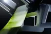 A close-up shot of a vegetable slicer in action, creating thin ribbons of a green vegetable. Produktbild-Vorschau