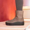 A close-up side view of a brown boot with a thick black sole. Produktbild-Vorschau