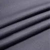 A close-up view of dark gray fabric, showing its texture and folds. Náhľad obrázku produktu
