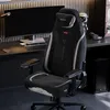 A gaming chair is set up in a home office or gaming room, with a computer monitor and other accessories visible. Anteprima dell’immagine prodotto