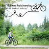 A young man rides an e-bike on a path through a forest. Produktbild-Vorschau