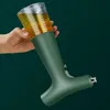 A hand holds a green oil sprayer with a clear, ribbed container filled with yellow liquid. Podgląd zdjęcia produktu