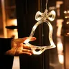 A hand holding a clear bell-shaped LED light decoration. Produktbild-Vorschau