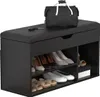 A black shoe bench with storage shelves and a padded top, with shoes and a bag on it. Produktbild-Vorschau