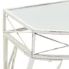A close-up view of the corner of a white metal side table with a glass top. Produktbild-Vorschau