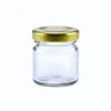 A clear, studio shot of a small, empty glass jar with a gold metal twist-off lid, isolated on a white background. Voir les images du produit