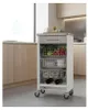 A kitchen cart with vegetables, dishes, and bottles in a modern kitchen. Anteprima dell’immagine prodotto