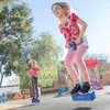 Two young girls are playing on a playground with pogo jumpers. Produktbild-Vorschau