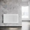 A white radiator is mounted on a marble-tiled wall in a room with a window showing a winter scene. Podgląd zdjęcia produktu
