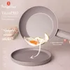 A frying pan with a fried egg being poured onto a plate, with marketing text and logos. Náhled obrázku produktu