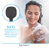 A woman is showering and holding a loofah, with a close-up of a showerhead in the upper left corner. Produktbild-Vorschau
