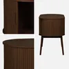 A collage of images showing a wooden cabinet with a slatted door and legs. Produktbild-Vorschau