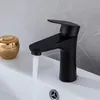 A black faucet in a bathroom sink with water running. Náhľad obrázku produktu