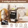 A side table with storage next to a sofa, with text overlays highlighting features. Voir les images du produit