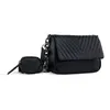A black handbag and a small matching coin purse are displayed against a white background. Produktbild-Vorschau