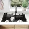 A kitchen sink with running water, dishes, and accessories. Produktbild-Vorschau
