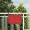 A red hanging balcony table is attached to a white railing, with green trees and a cloudy sky in the background. Anteprima dell’immagine prodotto