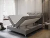 A grey upholstered bed with its mattress lifted to reveal storage space underneath. Produktbild-Vorschau