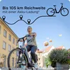 A woman riding an e-bike through a European-style town. Produktbild-Vorschau