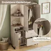 A corner of a modern wardrobe with doors open, showing clothes hanging and shelves with decorative items. A basket of pillows is visible in the foreground. Produktbild-Vorschau