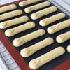 A baking mat with several rows of piped dough, likely for cookies or eclairs. Podgląd zdjęcia produktu