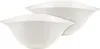 Two white ceramic bowls are stacked on a white background. Voir les images du produit