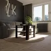 A modern living room with a couch, coffee table, plant, and window. Produktbild-Vorschau