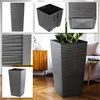 A collage of images showing a tall, square, textured planter in a dark gray color, with close-ups of its texture and an interior insert. The main image shows the planter in a living room setting. Produktbild-Vorschau