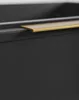 A close-up view of the edge of a dark gray cabinet with a gold handle. Anteprima dell’immagine prodotto