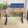 A modern L-shaped standing desk with dual monitors, keyboard, and mouse, set against a window view of mountains. Anteprima dell’immagine prodotto