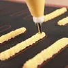 A close-up shot of a baking mat with piped dough being formed into long, ridged shapes. Podgląd zdjęcia produktu