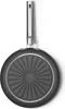 The underside of a frying pan with a patterned base and a silver handle. Produktbild-Vorschau