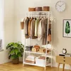 A white garment rack with clothes and accessories displayed in a room. Anteprima dell’immagine prodotto