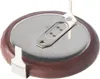 A close-up view of a coin cell battery with metal tabs. Produktbild-Vorschau