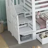 Close-up view of the storage stairs and lower bunk of a white bunk bed, with toys and bedding visible. Produktbild-Vorschau