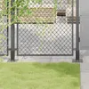 A close-up view of a metal fence post base with green grass in the foreground and a wooden fence in the background. Produktbild-Vorschau