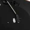 A close-up view of a turntable's tonearm and cartridge. Náhľad obrázku produktu