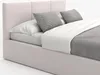 A close-up view of a bed with pillows and bedding. Produktbild-Vorschau