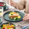 A person is eating a meal from a set of dishes. Náhled obrázku produktu