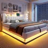 A modern bedroom with a large, upholstered bed as the focal point, illuminated by soft LED lighting. Náhľad obrázku produktu
