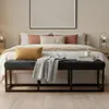 A bedroom scene with a bed, bench, and bedside tables. Náhled obrázku produktu