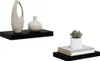 Two black floating shelves are displayed against a white background. The left shelf holds two decorative vases, one tall and textured beige, the other a smaller, smooth white. The right shelf displays a stack of three books topped with a small potted succu Náhľad obrázku produktu
