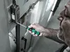 A person is using a screwdriver to work on a piece of machinery. Anteprima dell’immagine prodotto