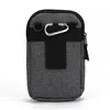 A gray fabric holster bag with a carabiner clip and a belt loop is shown against a white background. Produktbild-Vorschau