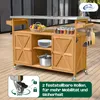 An outdoor kitchen island/serving cart with a stainless steel top, wooden cabinets, and shelves, displayed on a wooden deck. Produktbild-Vorschau