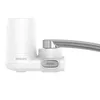 A white Philips water filter attached to a faucet spout. Náhled obrázku produktu